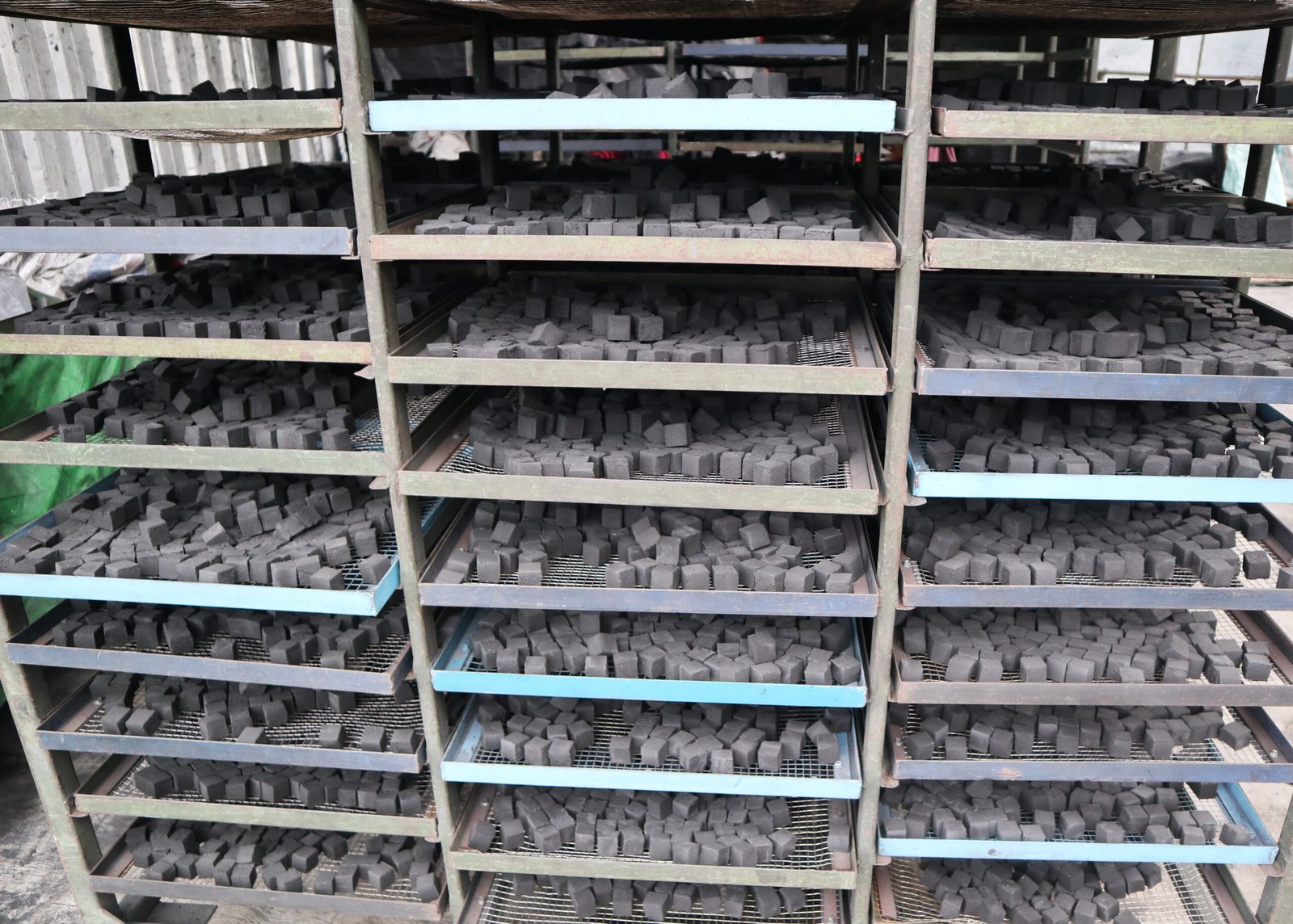 Cooling coconut shell charcoal briquettes after oven drying